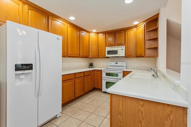 kitchen featuring light tile patterned floors, kitchen peninsula, white appliances, a textured ceiling, and sink