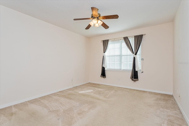 empty room featuring light carpet and ceiling fan