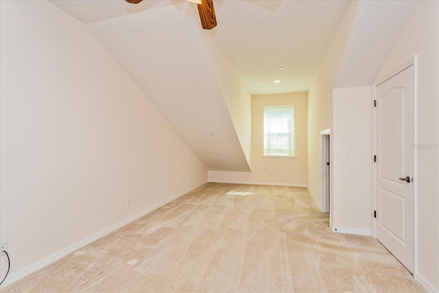 bonus room featuring light carpet, ceiling fan, and vaulted ceiling