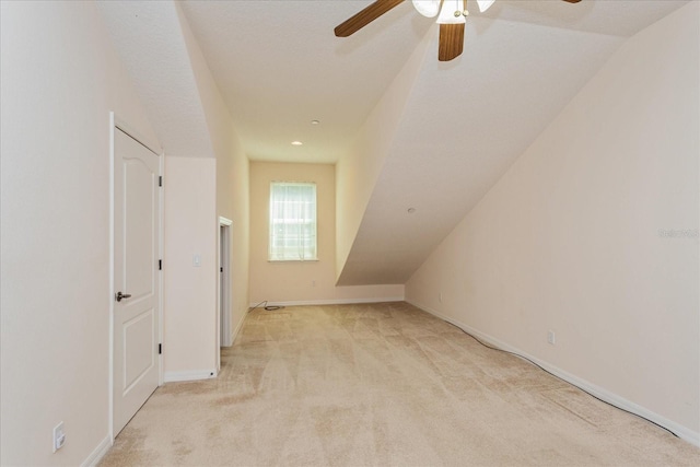 bonus room featuring ceiling fan, light colored carpet, a textured ceiling, and lofted ceiling