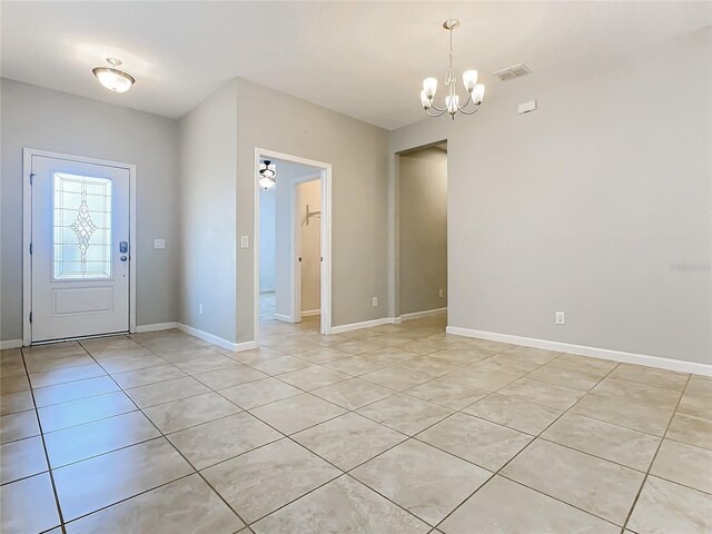 entryway featuring light tile patterned flooring and a chandelier