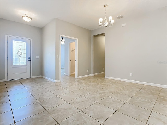 entryway with baseboards, light tile patterned flooring, visible vents, and an inviting chandelier