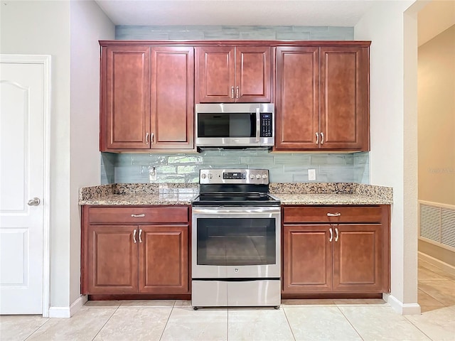 kitchen with light stone counters, appliances with stainless steel finishes, backsplash, and visible vents