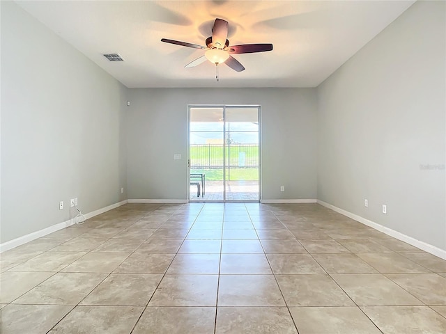 spare room with baseboards, visible vents, ceiling fan, and light tile patterned flooring