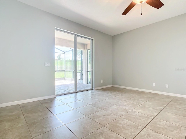 unfurnished room featuring light tile patterned floors, baseboards, and a ceiling fan