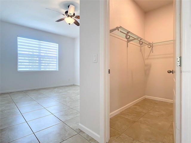 spacious closet featuring light tile patterned floors and a ceiling fan