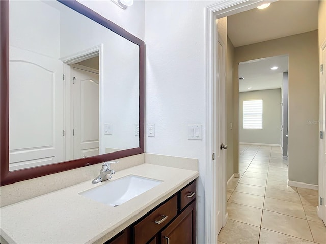 bathroom featuring tile patterned flooring, vanity, and baseboards