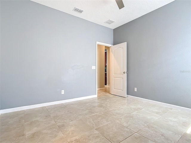 unfurnished room with visible vents and baseboards