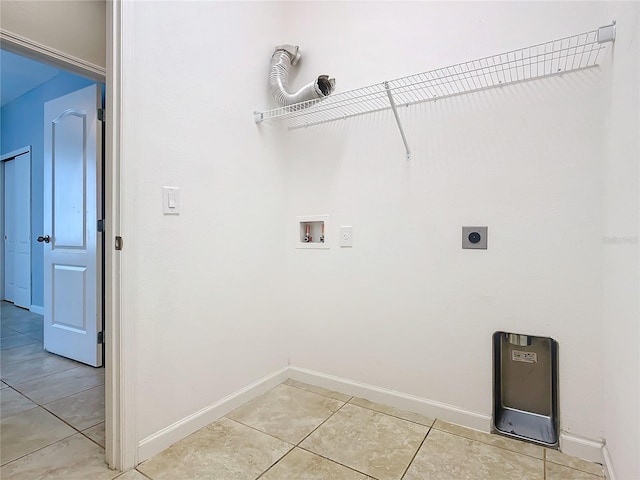 washroom featuring light tile patterned floors, laundry area, baseboards, hookup for a washing machine, and hookup for an electric dryer