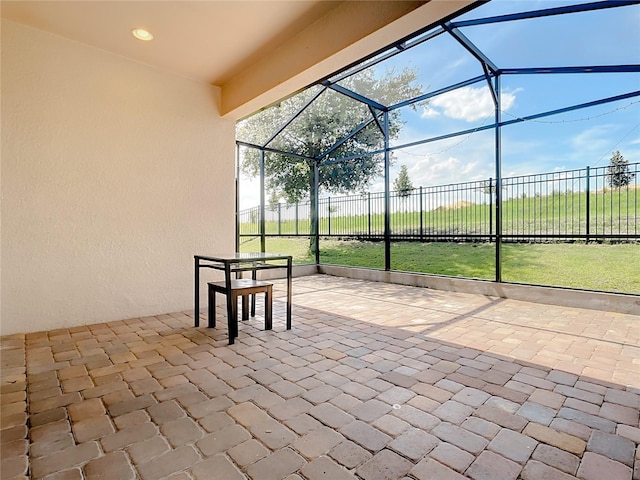 view of patio featuring a lanai and fence