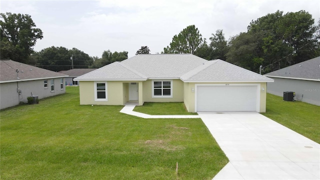 ranch-style house with a garage, cooling unit, and a front yard