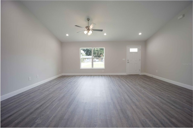 spare room with dark wood-type flooring and ceiling fan