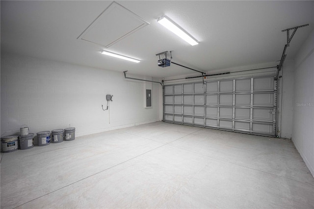 garage with a garage door opener and electric panel