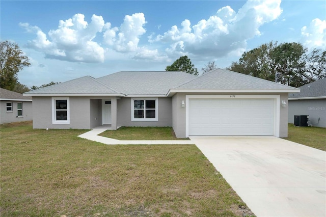 ranch-style home featuring a garage, central AC, and a front lawn