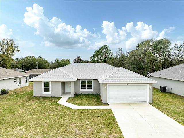 ranch-style home featuring a garage, central AC unit, and a front yard