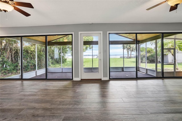 doorway featuring ceiling fan and dark hardwood / wood-style floors