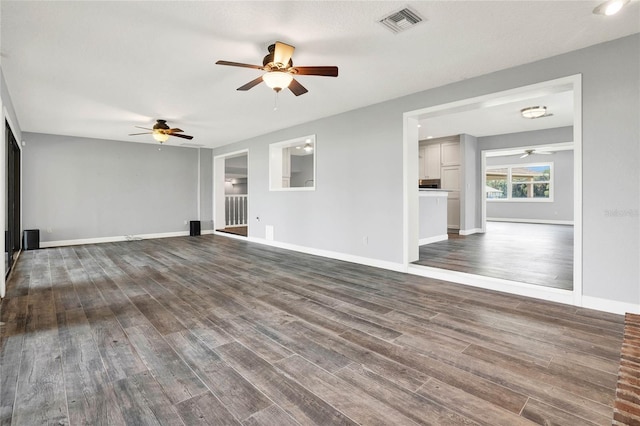 unfurnished living room featuring a textured ceiling, dark hardwood / wood-style flooring, and ceiling fan