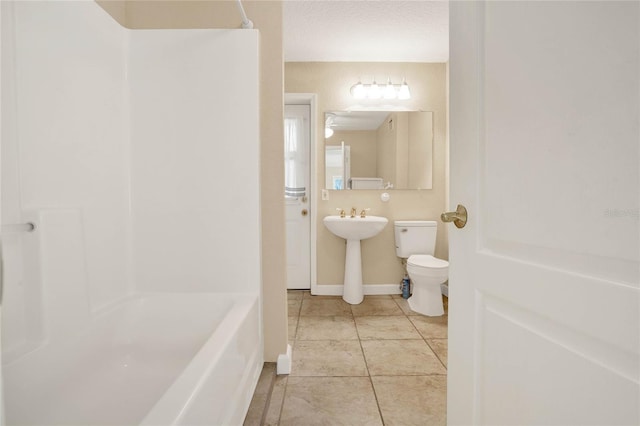 bathroom featuring tile patterned flooring and toilet