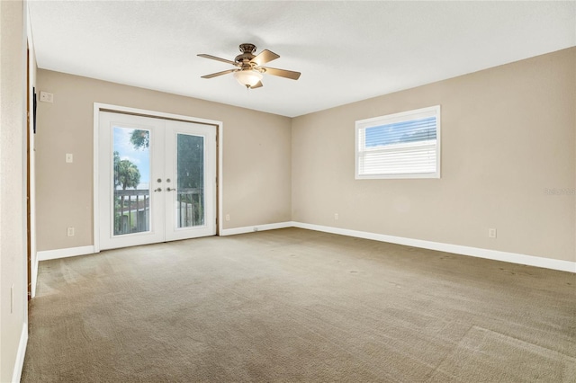 carpeted empty room featuring ceiling fan and french doors