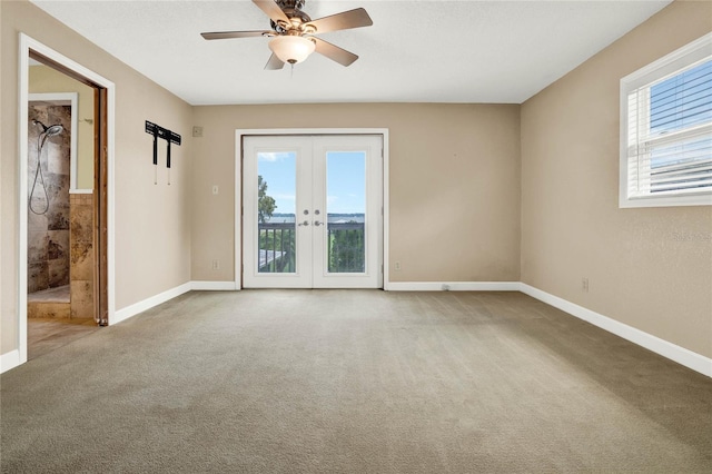 spare room with carpet flooring, ceiling fan, and french doors