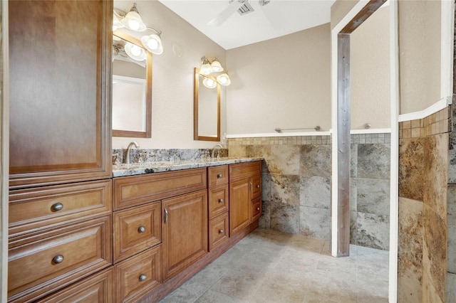 bathroom with vanity, tile patterned floors, tile walls, and ceiling fan