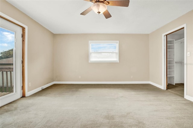 carpeted empty room featuring ceiling fan