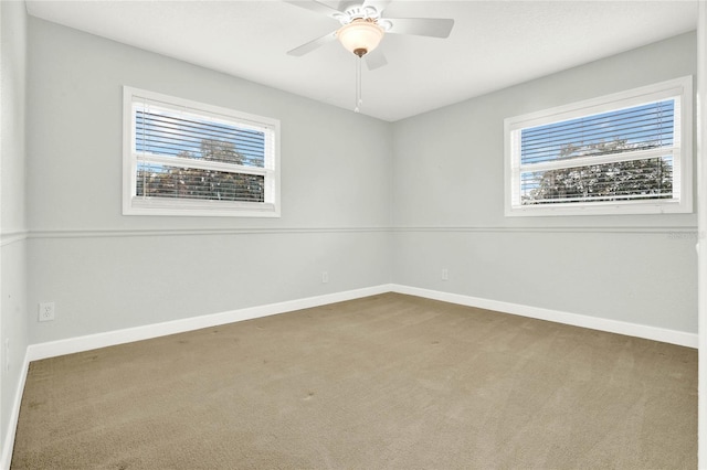 spare room featuring carpet flooring, ceiling fan, and a healthy amount of sunlight