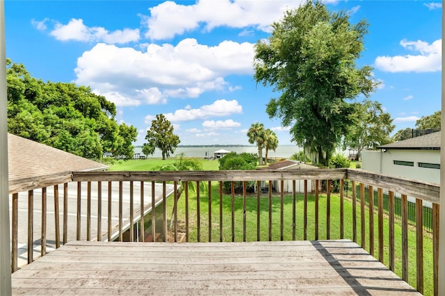 wooden terrace with a lawn and a water view