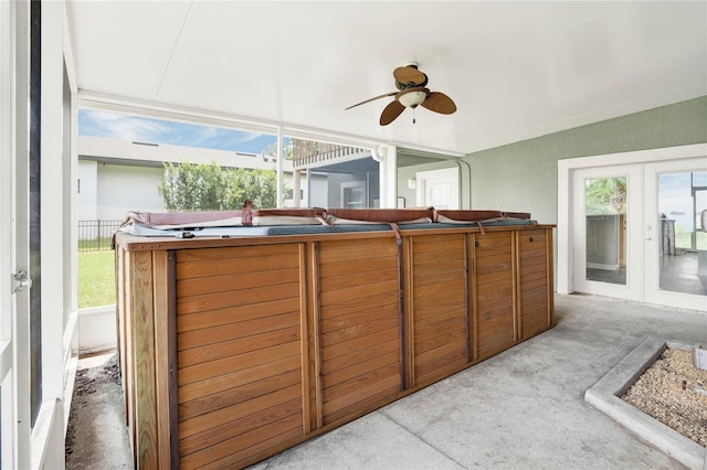 sunroom featuring a wealth of natural light, french doors, ceiling fan, and a hot tub