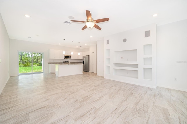 unfurnished living room featuring built in features, light tile patterned floors, and ceiling fan