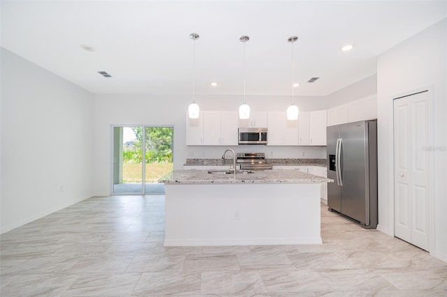 kitchen with light tile patterned flooring, light stone countertops, stainless steel appliances, and white cabinets