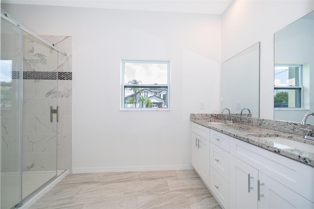 bathroom featuring walk in shower, dual vanity, and tile patterned floors