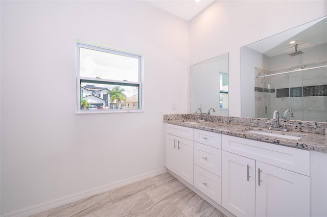 bathroom featuring tile patterned floors, walk in shower, and dual bowl vanity