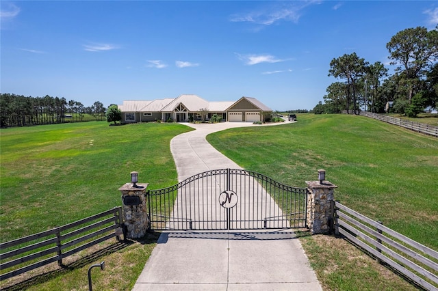 view of gate with a garage and a yard