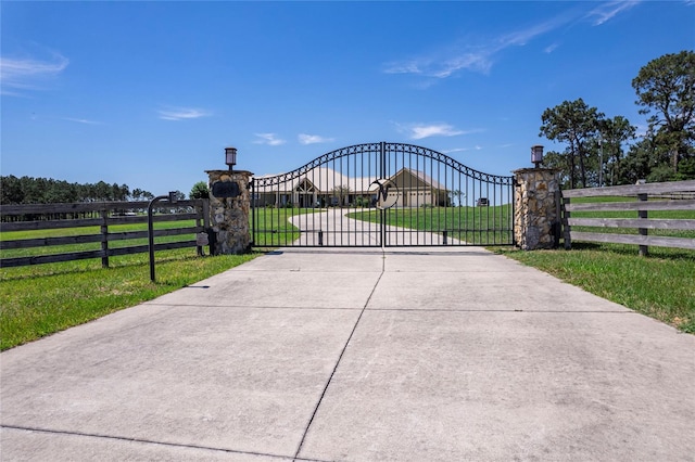 view of gate featuring a yard