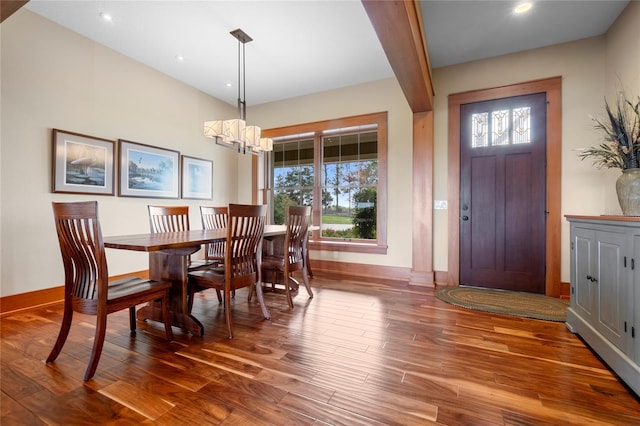 dining room featuring dark hardwood / wood-style floors and a chandelier