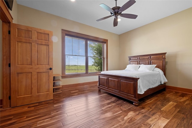 bedroom featuring ceiling fan and dark hardwood / wood-style floors