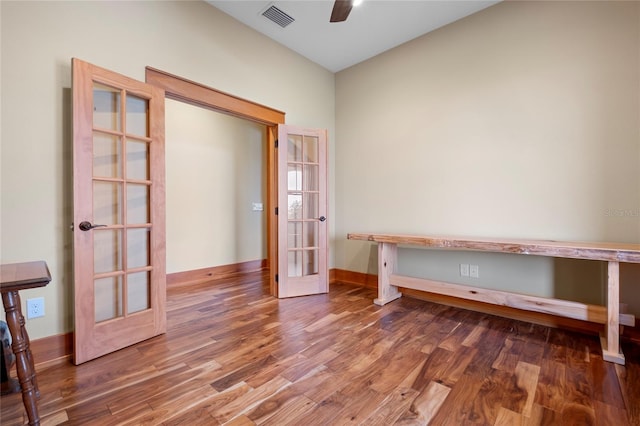 interior space with ceiling fan, dark hardwood / wood-style flooring, and french doors