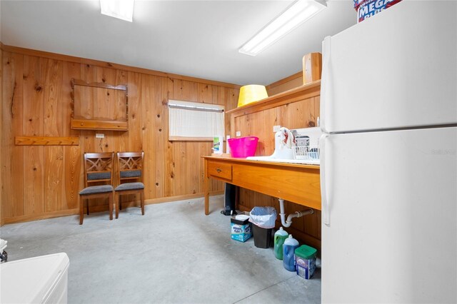 kitchen with wood walls and white refrigerator