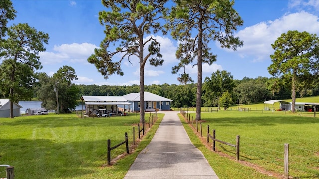 view of property's community featuring a yard and a rural view