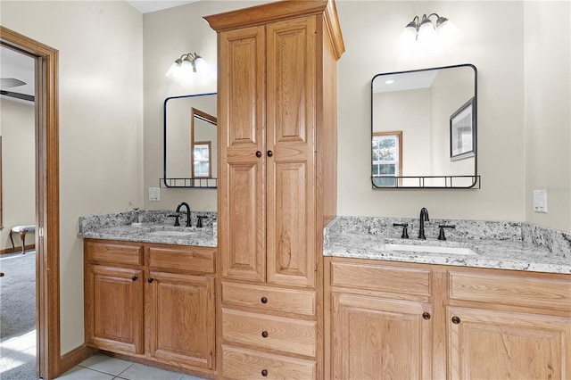 bathroom with tile patterned flooring and double vanity