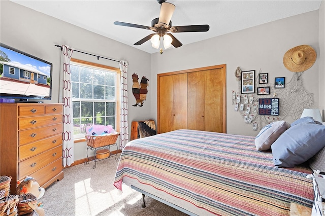 bedroom with light colored carpet, a closet, and ceiling fan