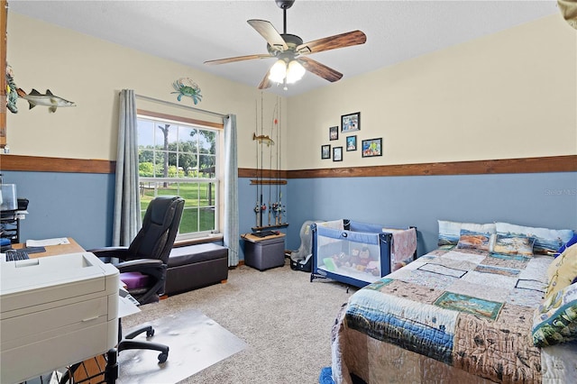 bedroom featuring a textured ceiling, ceiling fan, and carpet flooring