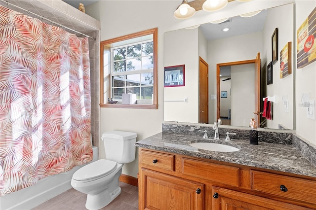 full bathroom featuring vanity, shower / bath combo with shower curtain, tile patterned flooring, and toilet