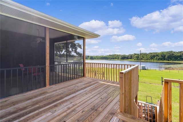 deck featuring a water view, ceiling fan, a yard, and a sunroom