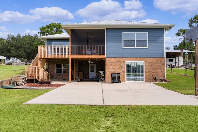 back of house featuring ceiling fan, a deck, a yard, a patio, and a sunroom