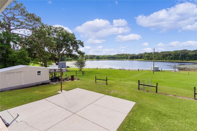 view of patio featuring a water view and an outbuilding