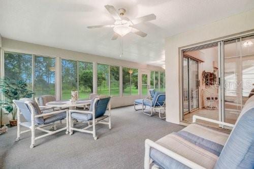 sunroom featuring ceiling fan