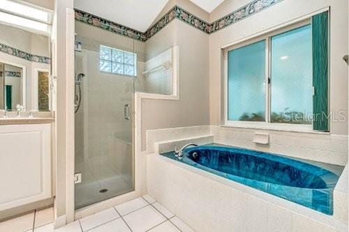 bathroom with vanity, plus walk in shower, and tile patterned floors