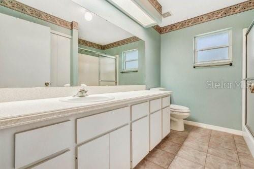 bathroom with vanity, tile patterned flooring, and toilet